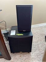 KLH speaker on top of RCA subwoofer showing size and front black grille with logos