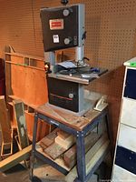 Front view of Craftsman band saw mounted on metal stand showing overall condition