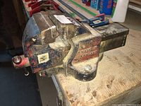 Side view of the heavy-duty bench vice showing the 'Made in England' mark and wear on the metal surface.