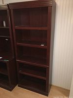 View of full bookshelf showing its height and shelf spacing next to a matching unit.