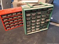Two hardware drawer units, one green and one red, placed side by side showing overall condition and quantity of drawers.