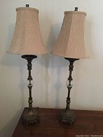 Photo showing both lamps fully assembled with shades, standing side by side on a surface against a plain background.