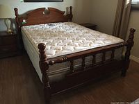 Full front view of assembled bed frame and mattress in room