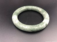 Top view of the jade bangle showing overall round shape and coloration.