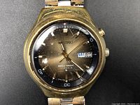 Front view of vintage Seiko Bell-Matic wristwatch with visible wear on the case and scratches on crystal.