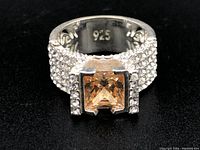 Front view showing the square citrine and rows of clear stones on band with 925 stamp inside.