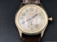 Close-up of Waltham watch face showing cream dial with Arabic numerals and sub-second dial.