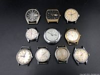 Group shot of ten watches arranged in three rows on black background