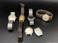 All six watches and heads displayed on black background