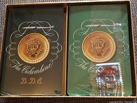 Photo showing two boxes of playing cards with gold presidential seals labeled 'The Columbine' D.D.E.