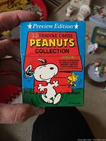 Close-up of unopened Peanuts Preview Edition 33 trading cards box featuring Snoopy and Woodstock.