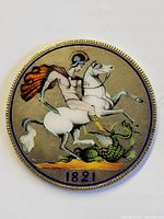 Close-up front view of the 1821 UK silver crown coin showing the enameled reverse image with a figure on horseback and the dragon, date 1821 at the bottom.