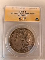 Obverse side of 1878 S Morgan Silver Dollar showing Lady Liberty and grading details from ANACS VF-35 with Rev of 1879 VAM-228B variety and cleaned note.