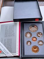 Full proof coin set with seven coins in protective case and certificate of authenticity.