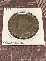 Front side (obverse) of 1856 Nova Scotia 1 Penny Token showing Queen Victoria profile and date 1856, mounted in protective holder.