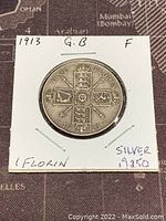 Reverse side of the 1913 Great Britain silver one florin coin displaying quartered shields, denomination, and date.