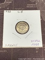 Reverse side of the 1938 Great Britain 3 Pence coin showing three shields design and date 1938.