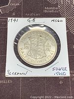 Reverse side of 1941 GB Half Crown showing royal shield and inscriptions including year and denomination.