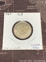 Reverse side showing crowned lion on crown, date 1945 and 'One Shilling' inscription.