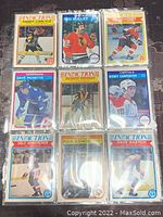 Photo showing nine assorted 1982-83 O-Pee-Chee NHL trading cards featuring players Randy Carlyle, Ted Bulley, Rick Vaive, Dave Pichette, Richard Brodeur, Bobby Carpenter, Dale Hawerchuk, Rick Kehoe, and Dave Babych in good condition.