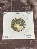 Obverse side showing caribou head, 25 cents denomination, Canada 1997, and silver purity mark.