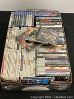 Full view of boxed video games showing varied titles and platform cases including Xbox, PS2, PS3, PS4, PC and Wii discs.
