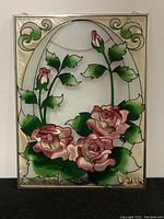 Full front view of stained glass panel showing the pink rose flowers inside oval clear center.
