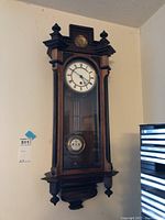 Full front view of wooden wall clock showing overall design