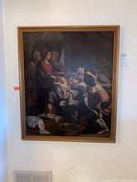 Frontal view of the full framed painting hanging on wall