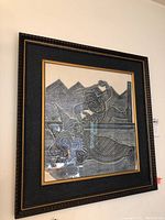 Full view of the first framed Thai rubbing print showing two traditional figures in ceremonial dress with intricate patterns.