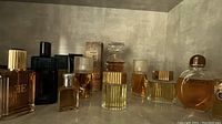 Shelf view of assorted perfume and cologne bottles in glass display