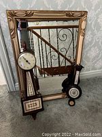 Photo showing the banjo clock, rectangular mirror, and barometer grouped together.