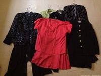 Photo showing five pieces of women's plus size dresswear including jacket and pants sets and a red skirt suit.