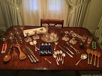 Full lot shot showing all utensils, flatware, glassware and accessories spread on table