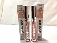 Two new Buxom Full-On Lip Cream lip gloss tubes with silver caps and their boxes labeled Celeste.