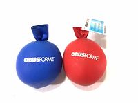 Two Obusforme hand stress balls, blue and red, shown side by side with logos visible.