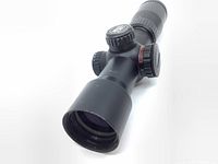 Close-up of front objective lens and scope body showing black matte finish and some wear marks.