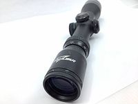 Front angle view showing objective lens and Excalibur branding on scope body.