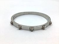 Full view of Swarovski silver rhodium plated bangle bracelet with five baguette-cut Swarovski crystals set around it.