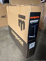 Box of Mongoose Rise 110 Team trick scooter showing front panel with product branding and image of scooter.