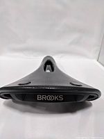 Front view showing the Brooks logo and the tapered nose of the saddle with the cutout channel.