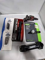 Overview of all included items -- pedals, pump, brake pads, stem, and headlight