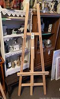 Full view of the adjustable wooden A-frame artist easel 67 inches tall, showing upright structural frame.