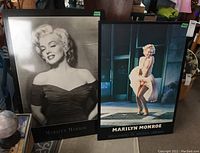 Two Marilyn Monroe posters side by side; one black and white portrait, one color image in iconic dress.