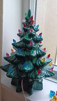 Green ceramic Christmas tree with multiple colorful bulb lights attached; view from side showing height and width.