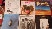 Full view of six vinyl album covers showing Eagles, Heart, Nazareth, ELO, and Paris Michel Legrand albums