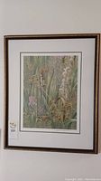 Framed and matted Robert Bateman print hanging on wall, showing full piece with frame and matting