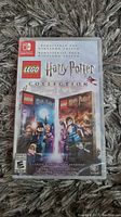 Front view of sealed Nintendo Switch LEGO Harry Potter Collection game box showing cover art and branding.