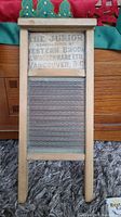 Full view of the wooden framed washboard with visible metal scrubbing surface and printed label on the upper wood panel.
