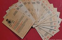 Photo of a fanned set of 30 brown kraft paper cards with red numbering and black text, titled Centennial RCMP Cards 1873 - 1973.